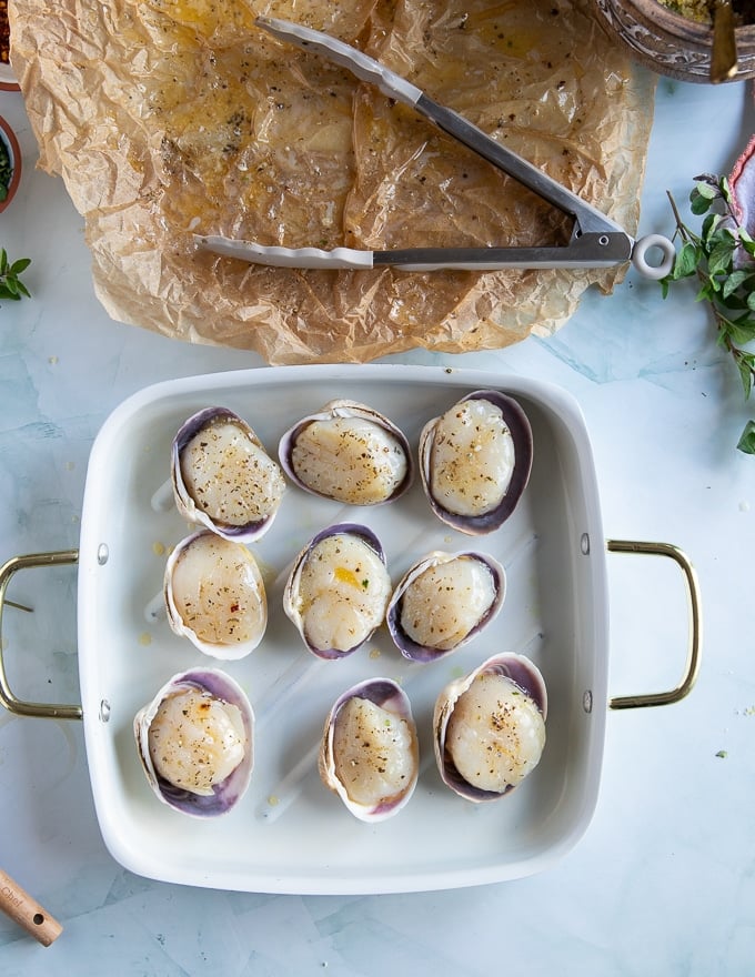 seasoned scallops on the baking shell on a cooking sheet