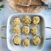 the topping is added over the scallops before baking