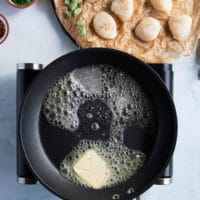 skillet preheating with lots of butter ready for pan seared scallops