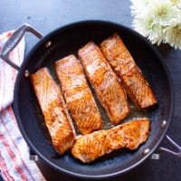 Salmon filets in skillet.