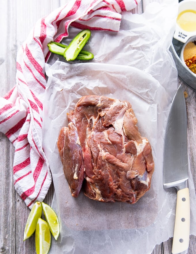 The cut of meat for sheet pan fajitas - a boneless leg of lamb on a cutting board