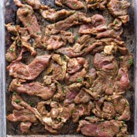 the meat spread in one single layer over a sheet pan and ready to broil