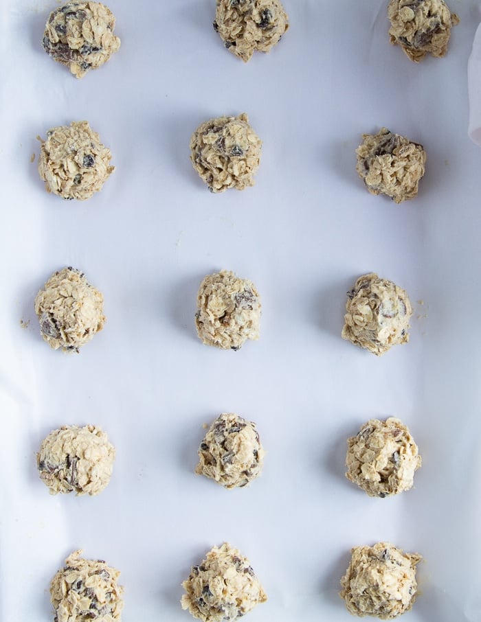 a sheet pan of raw oatmeal cookies ready to go in the oven