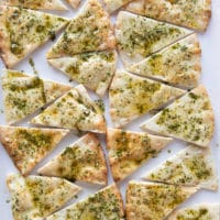 Pita chips on a baking sheet ready to bake in the oven