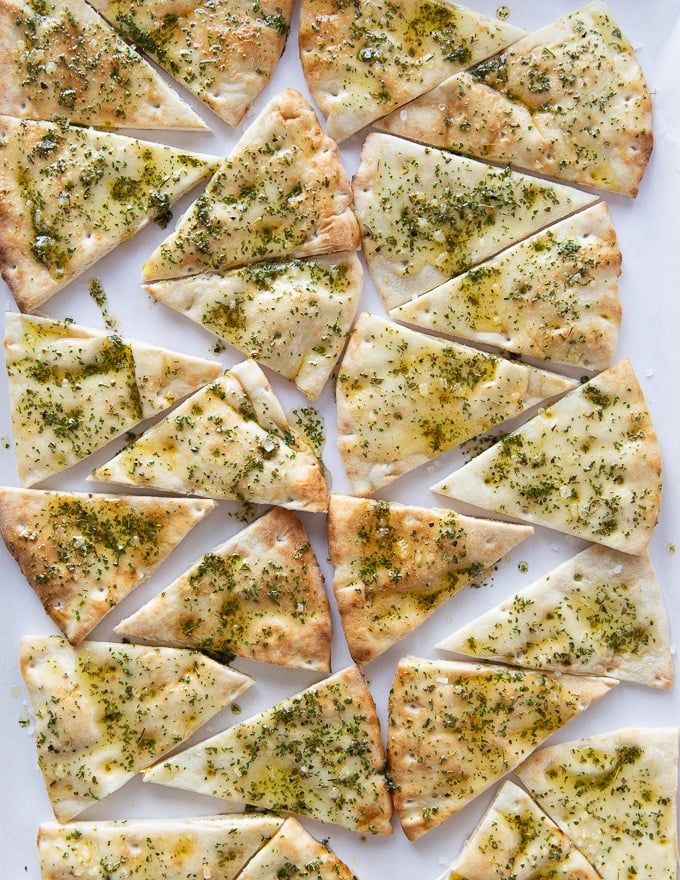 Pita chips on a baking sheet ready to bake in the oven