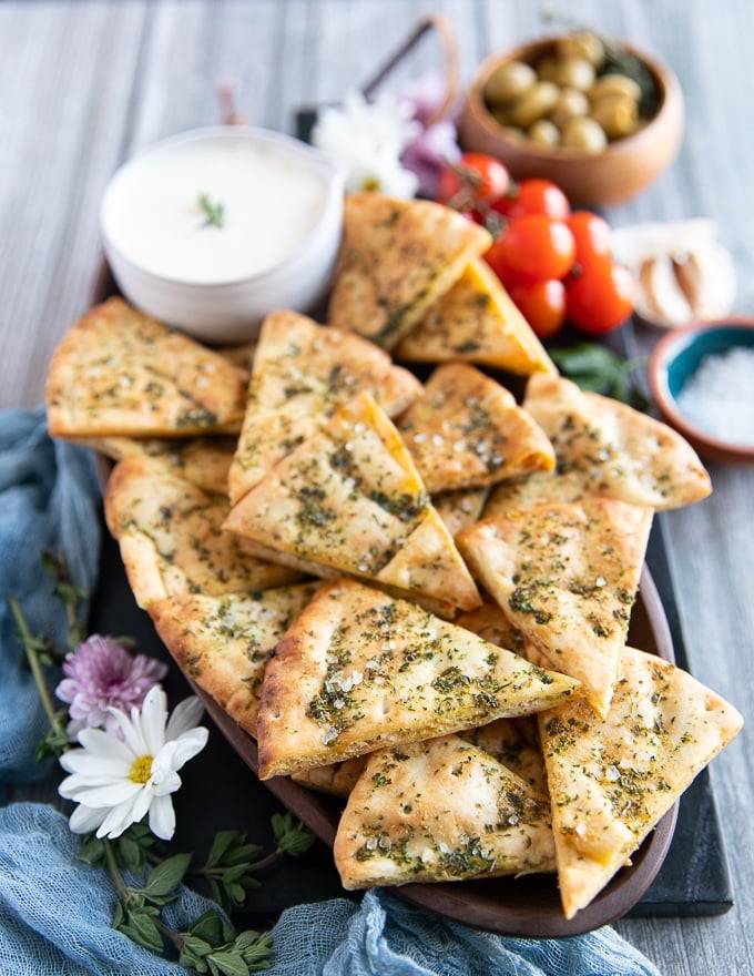 Side view of layered pita chips on a platter