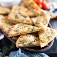 side view close up of a single pita chips showing the crisp