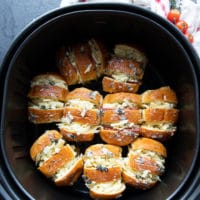 pizza rolls in an air fryer basket arrange single layer and ready to air fry