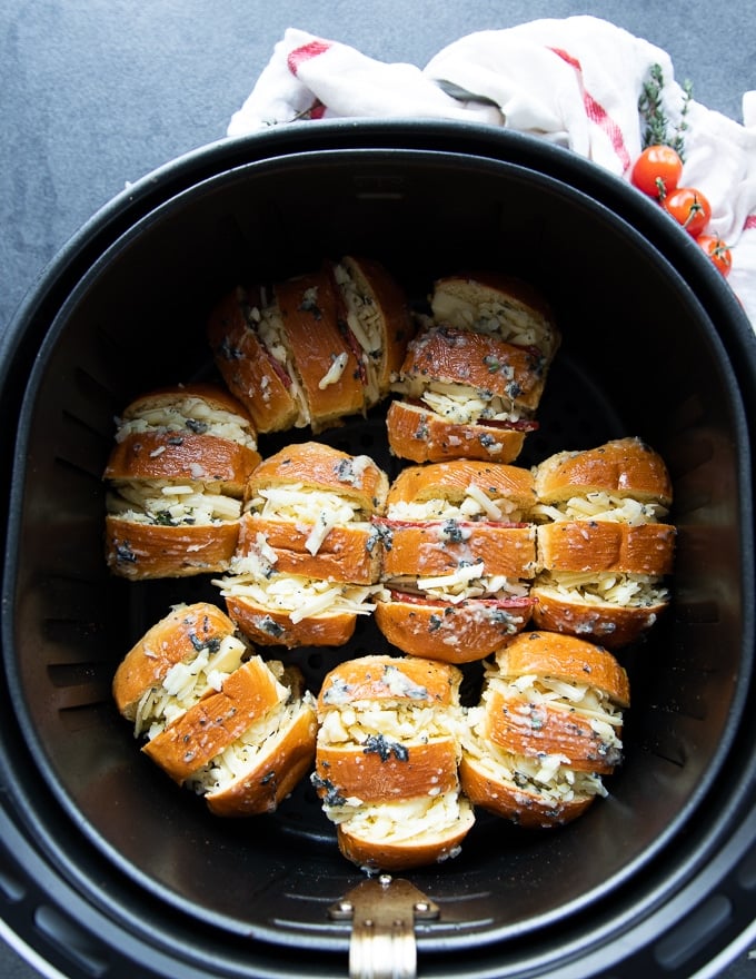 pizza rolls in an air fryer basket arrange single layer and ready to air fry