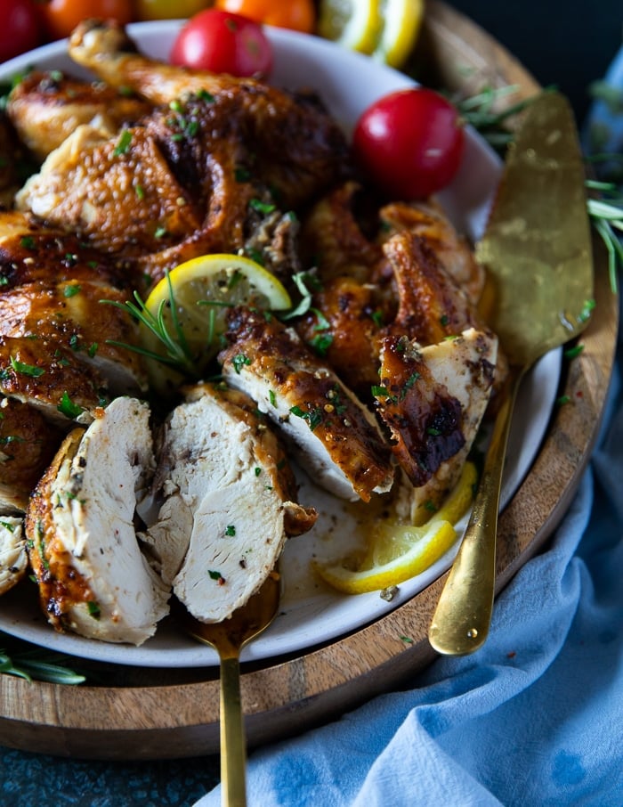 A fork holding a piece of air fryer whole chicken showing how juicy it is