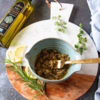 a bowl with the spice mixture and garlic and olive oil mixed in and ready for the chicken