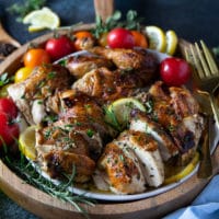 cutting up a whole chicken into pieces to serve on a plate