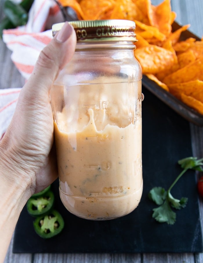 nacho cheese sauce placed in a mason jar to store in the fridge