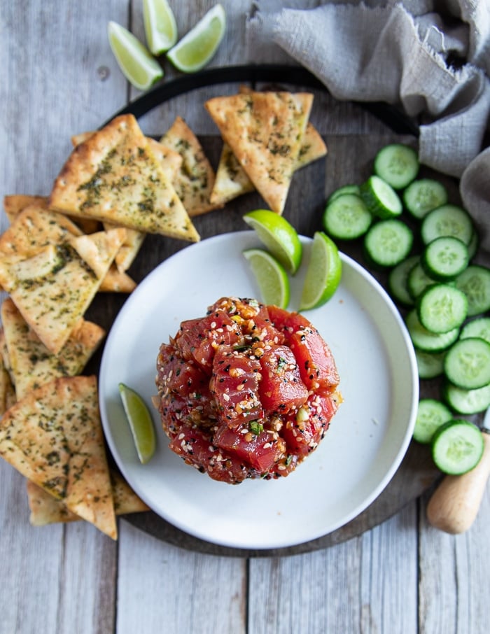 top view of tuna tartare recipe surrounded by pita chips, cucumber skices