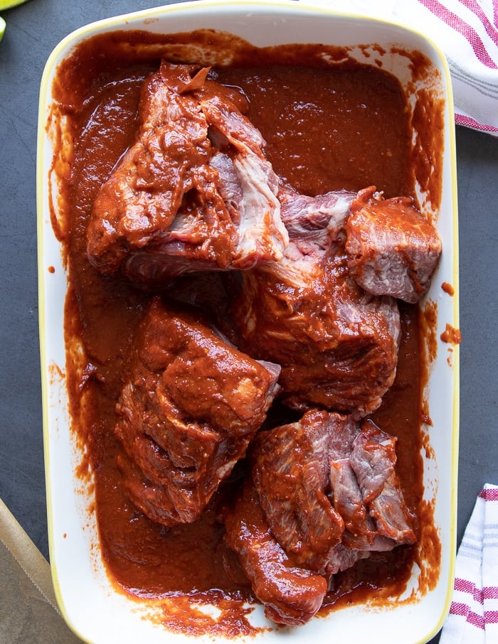 beef chuck meat for the birria tossed in the sauce to marinade