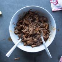 bowl of birria meat ready and flavored with some sauce