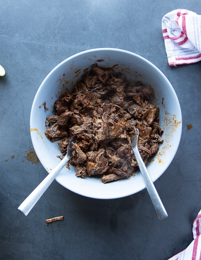 bowl of birria meat ready and flavored with some sauce