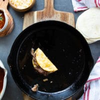 the other half of the tortilla folded over to create the perfect birria tacos