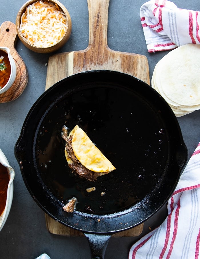 the other half of the tortilla folded over to create the perfect birria tacos