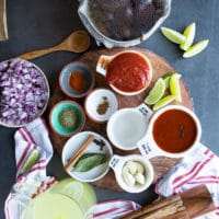 Ingredients for the birria tacos sauce including chipotle, tomatoes, whole spice, vinegar, garlic, onions, dried spices and stock