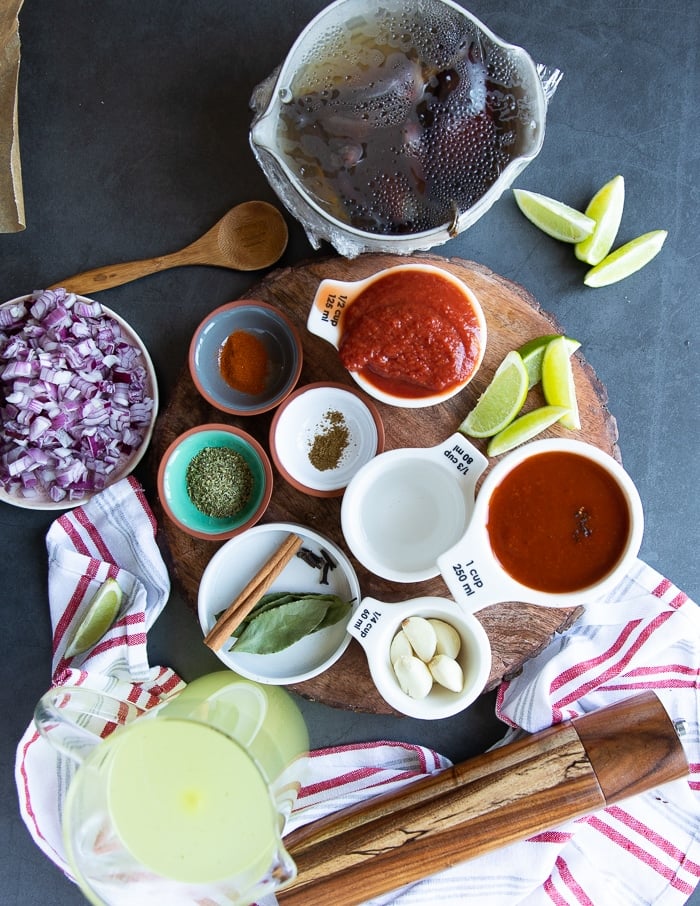 Ingredients for the birria tacos sauce including chipotle, tomatoes, whole spice, vinegar, garlic, onions, dried spices and stock