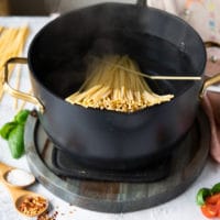 Bucatini pasta coking in boiling water