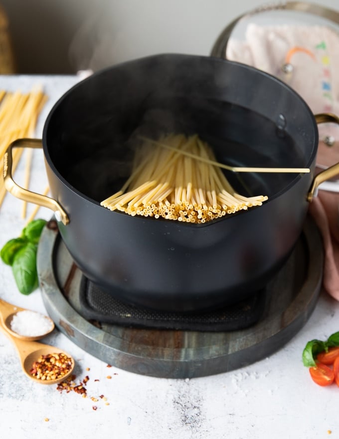 Bucatini pasta coking in boiling water