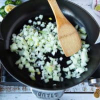 onions being cooked in oil over a medium high heat skillet until soft