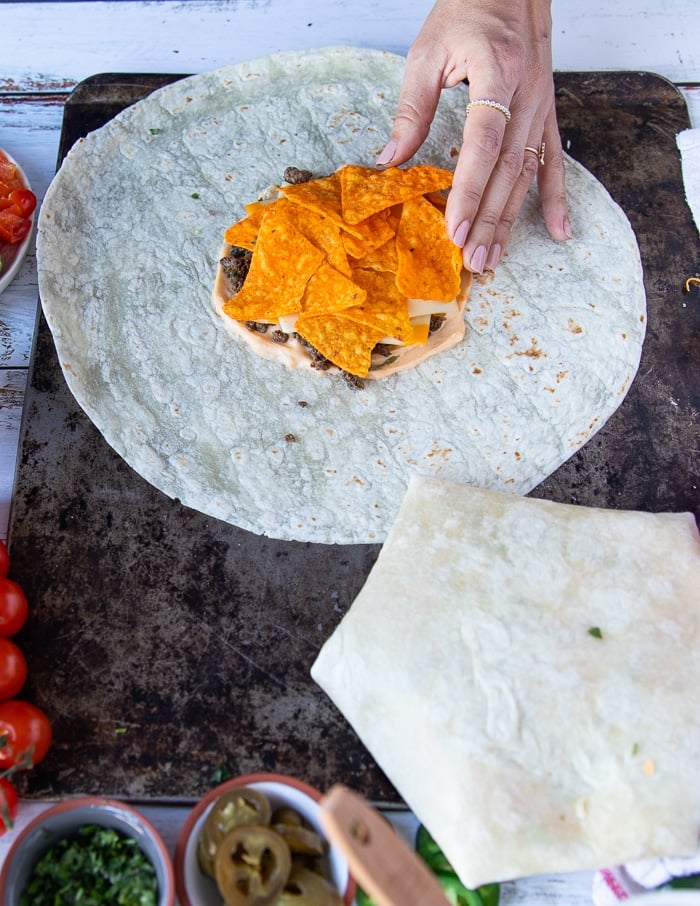 A hand adding in tortilla chips in case you don't have tostadas