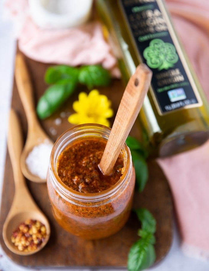 top down view of sun dried tomato pesto in a jar.