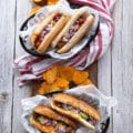 two plates of air fryer hot dogs all dressed up differently showing the variety of hot dog toppings