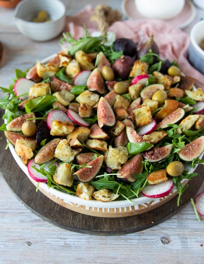 Преостали састојци бурата салате се додају у тањир за салату укључујући ротквице, крутоне, маслине