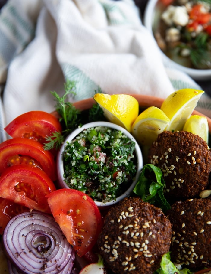 tabouleh salad added into a small bowl and placed next to the falafel