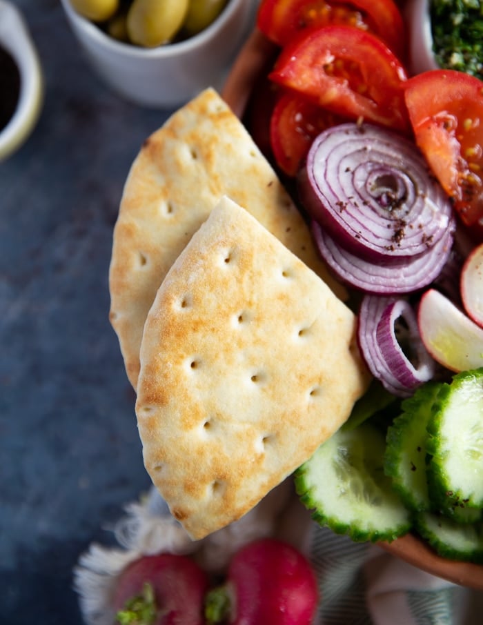 pita bread added to the side of the bowl