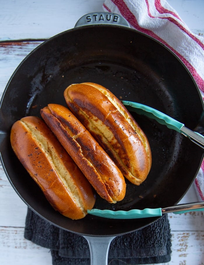 golden and toasted new england buns in a skillet ready for the lobster roll