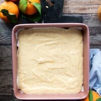 The mandarin orange cake batter poured into a square baking dish