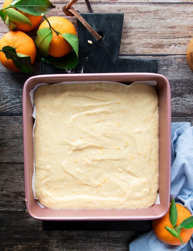 The mandarin orange cake batter poured into a square baking dish