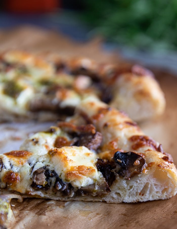 slices of mushroom pizza, side view.