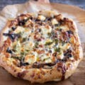 Top-down view, close-up mushroom pizza on a pizza peel.