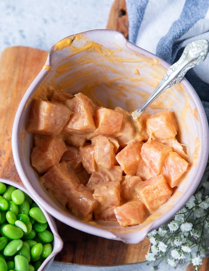 a bowl of sushi grade salmon mixed with spicy mayo to make spicy salmon