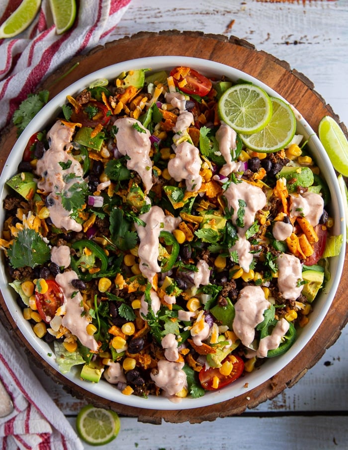 dressing poured over the taco salad recipe to finalize the salad