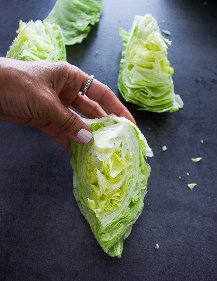 a hand holding the4 cut up wedge to show how it looks