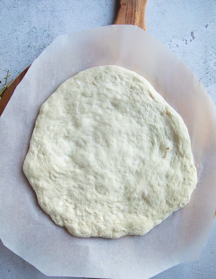 stretched no knead pizza crust ready for toppings.