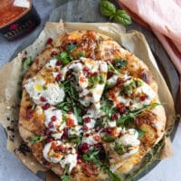 finished burrata pizza on a pizza peel.