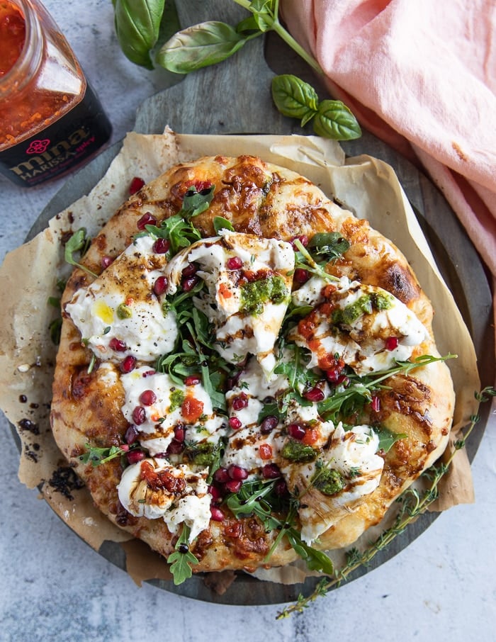 finished burrata pizza on a pizza peel.