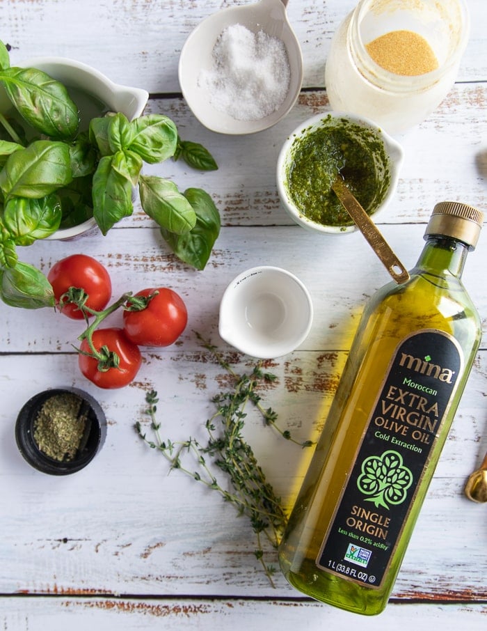 caprese pizza Ingredients: basil, salt, garlic powder, basil pesto, tomatoes, oregano, olive oil.