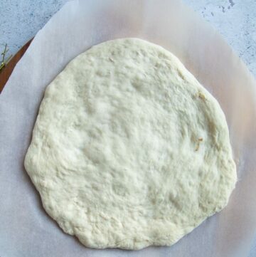 stretched no knead pizza crust ready for toppings.