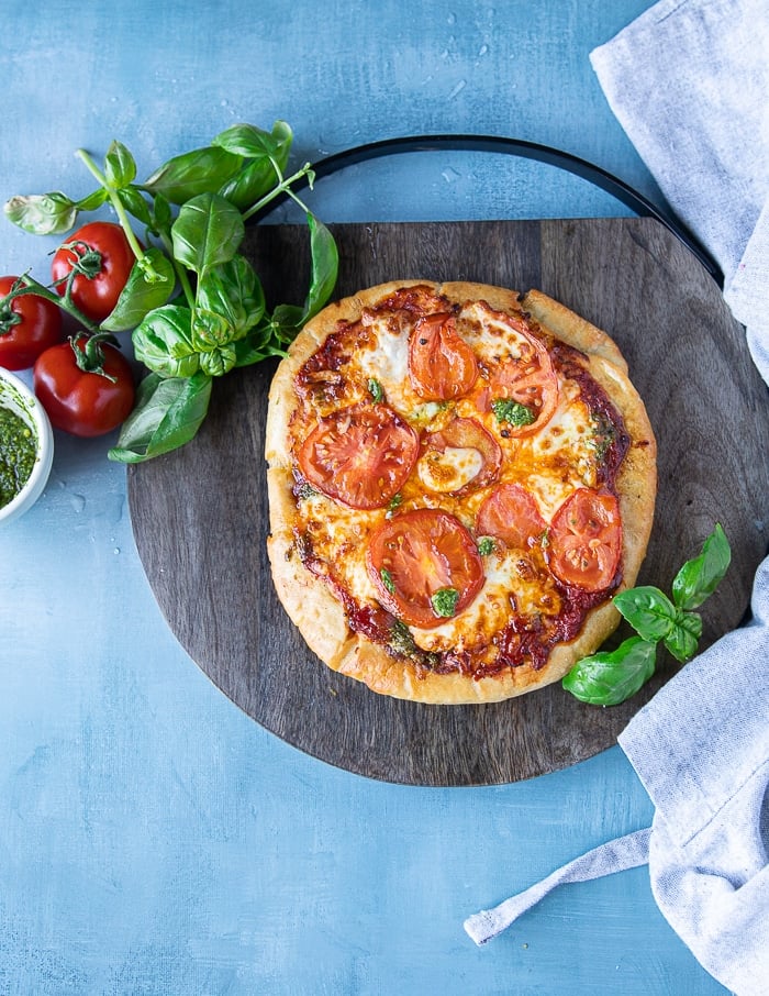 air fryer pizza ready to serve on a wooden board