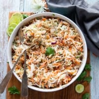 two spoons mixing up the dressing with the slaw to make the fish taco slaw recipe