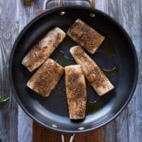 mahi mahi fish in a skillet cooking